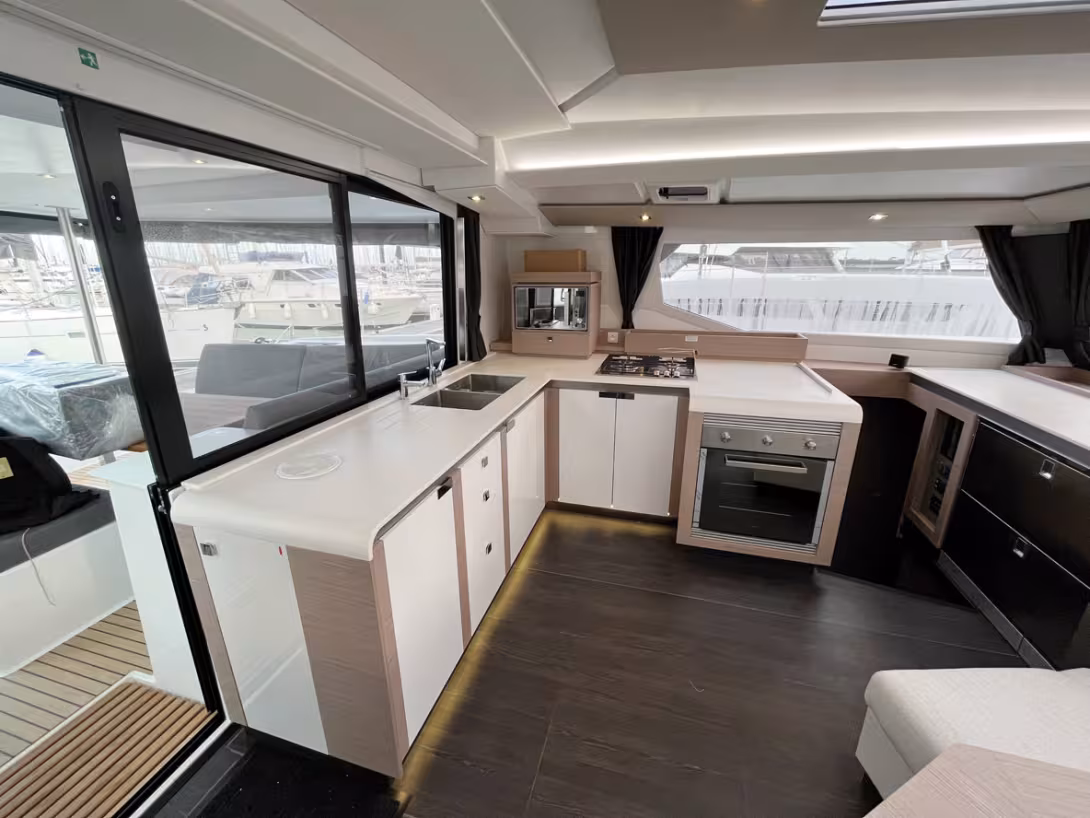 The dining area extends toward the center with a comfortable seating. Note the overhead windows that allow you to keep an eye on the sail plan.